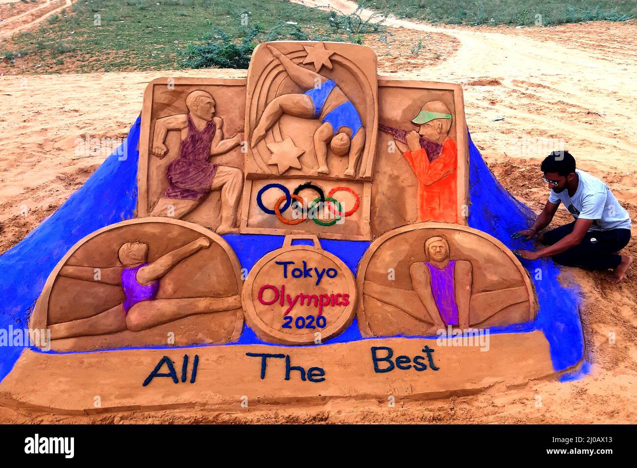 Indian sand artist Ajay Rawat creates sand arts on "Tokyo Olympics" in
