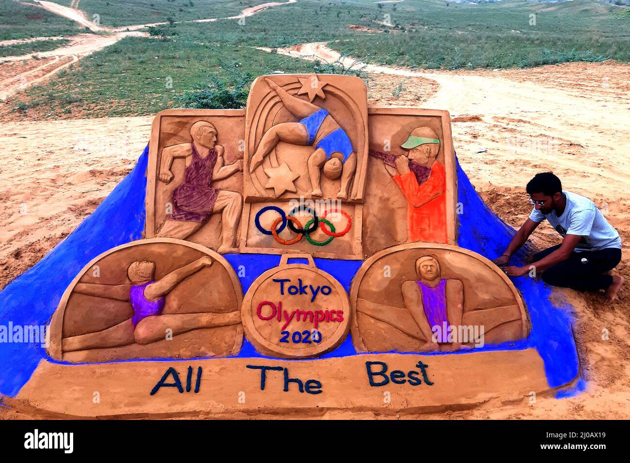 Indian sand artist Ajay Rawat creates sand arts on "Tokyo Olympics" in