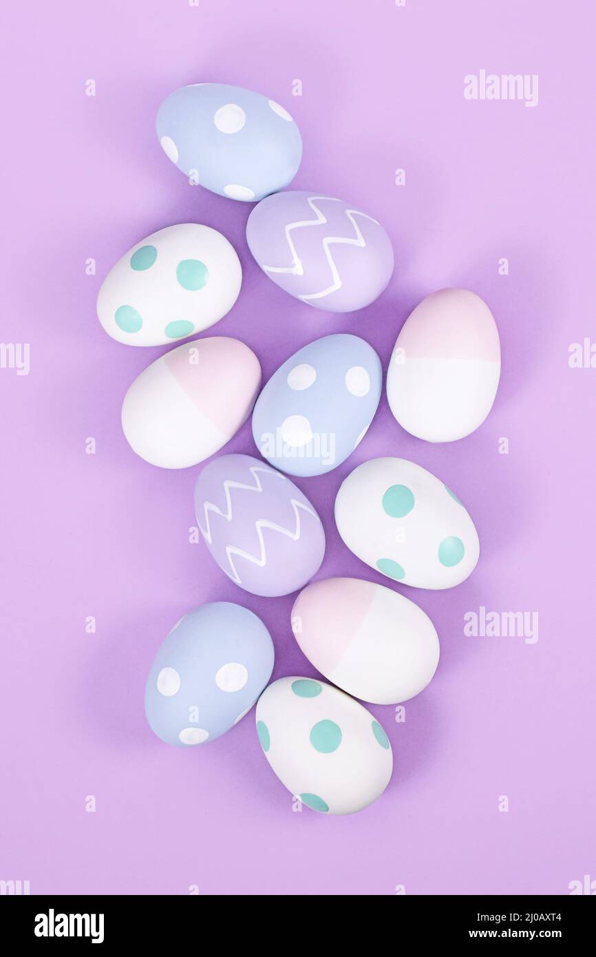 Top view of group of pastel colored easter eggs on violet background Stock Photo