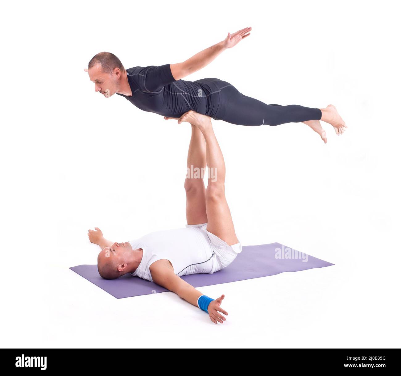 Practicing Acro Yoga exercises in group / Bird Pose Stock Photo Alamy