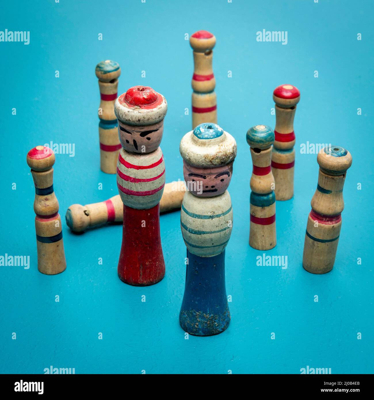Closeup shot of wooden sailor figurines on a blue background Stock Photo