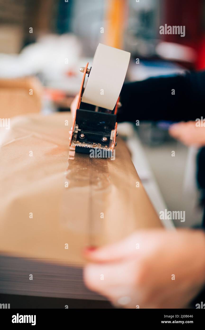 Woman working in printing factory. Printing tools Stock Photo