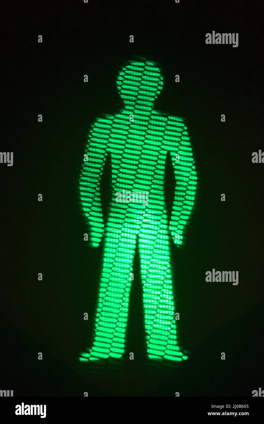 Green man go pedestrian traffic light Stock Photo