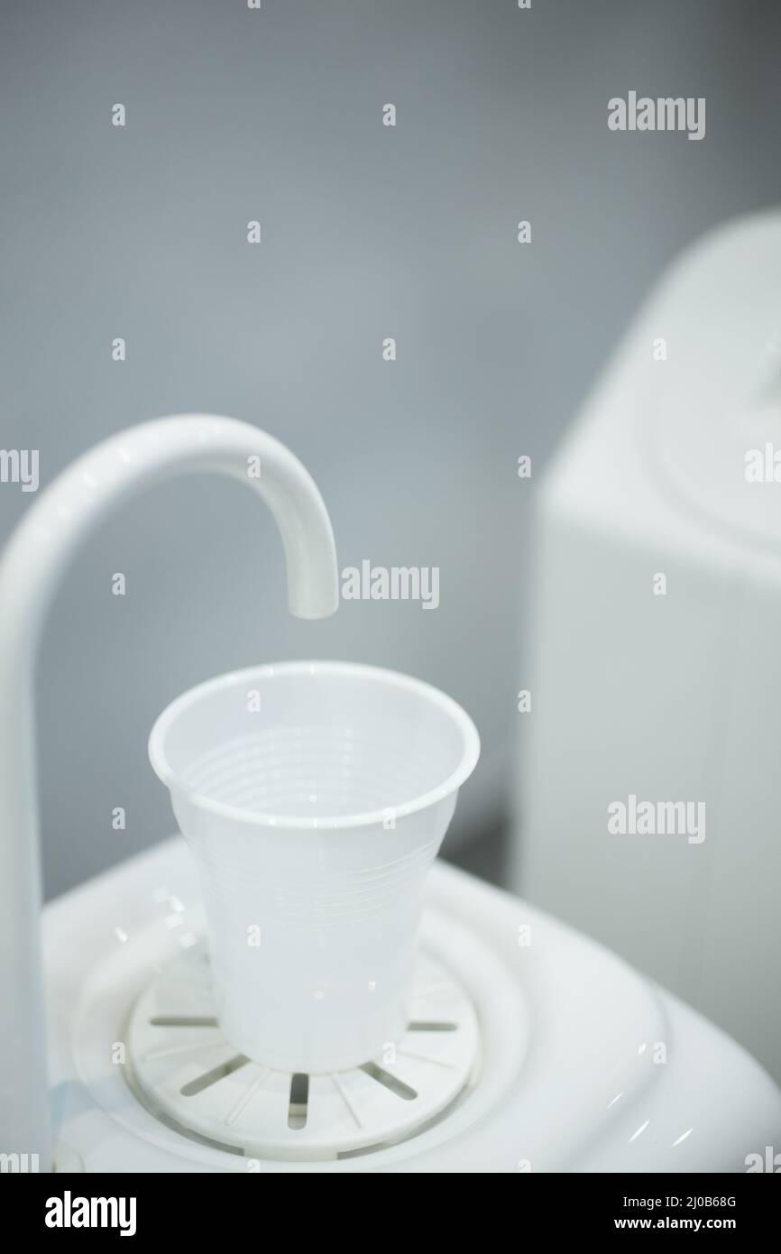 Dentist water cup tap filler in dental clinic Stock Photo