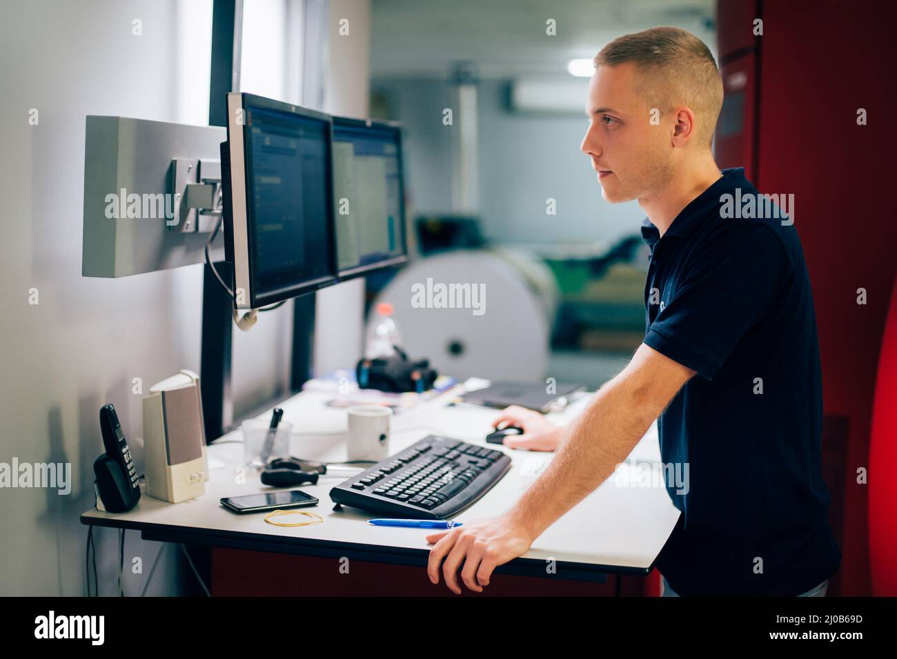 Young man working in printing factory. Printing Press Stock Photo - Alamy