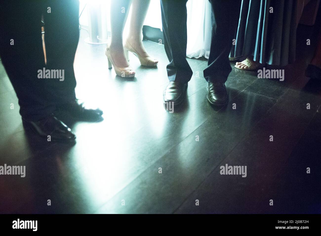 Legs of men and young lady social event wedding party Stock Photo
