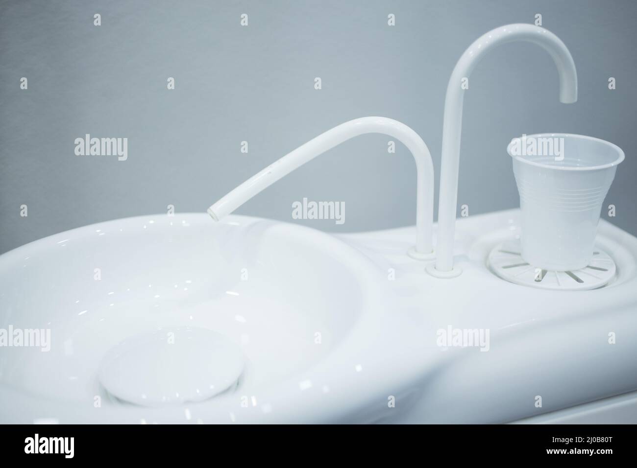 Dentist water cup tap filler in dental clinic Stock Photo