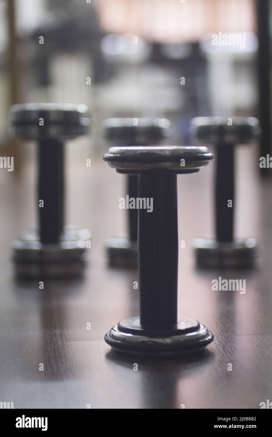 Dumbbell gym metal weights in gym health club Stock Photo
