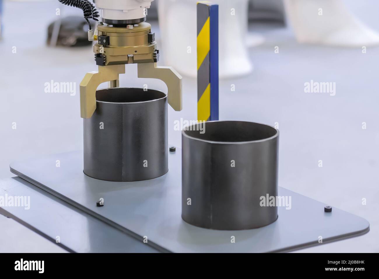 Pick and place robotic arm manipulator moving cylindrical metal workpiece Stock Photo Alamy