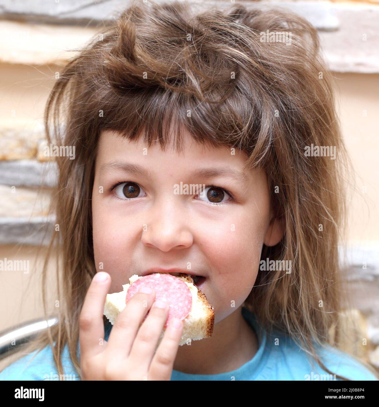 Two children eating one sandwich hires stock photography and images