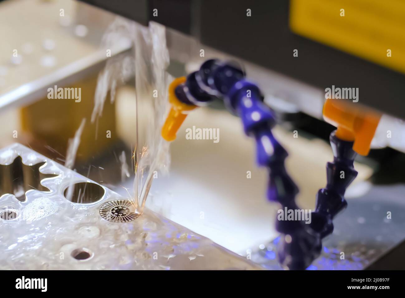 Wire cutting machine working with sheet metal with sparks at factory ...