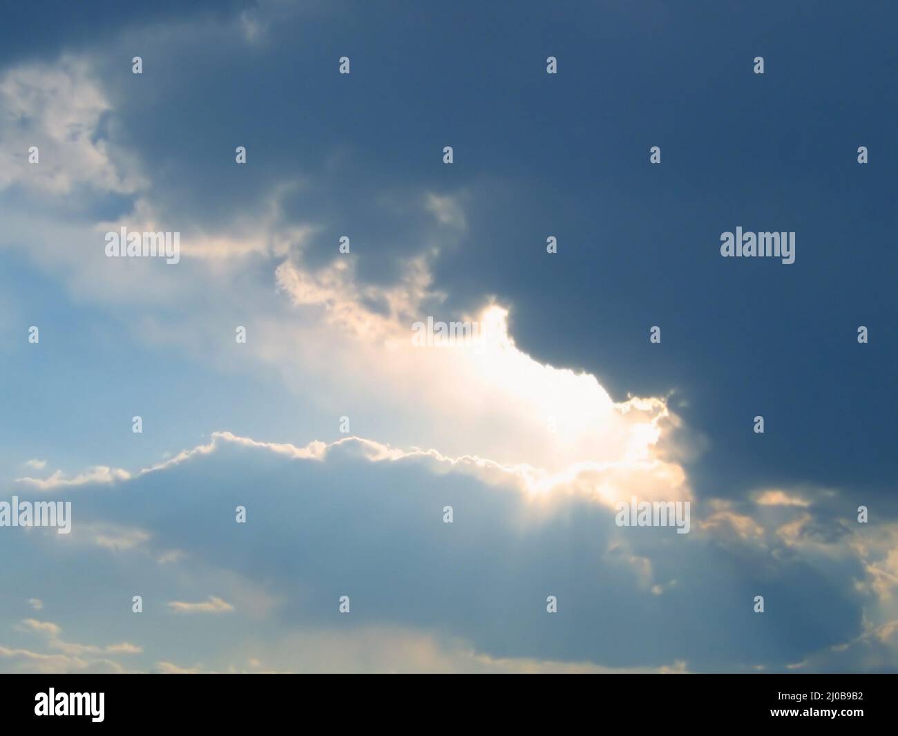 Rain clouds and rays of sunlight Stock Photo