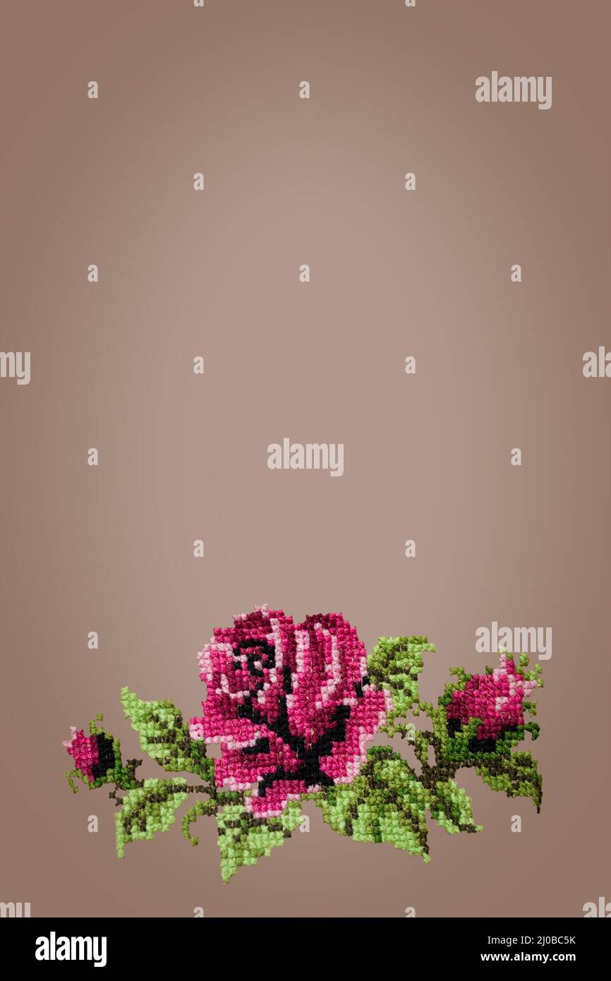 Cross embroidered rose on beige background Stock Photo