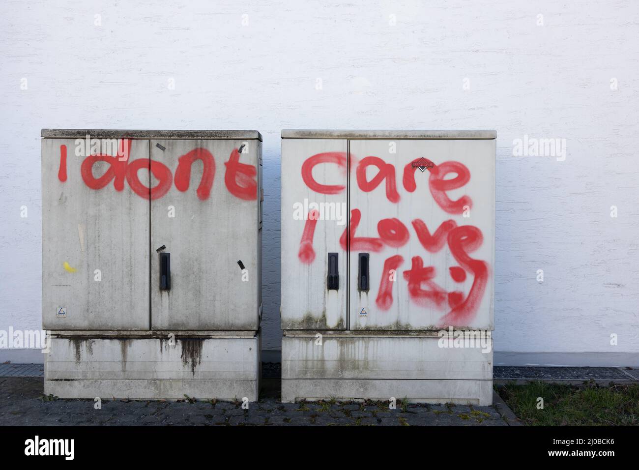 Regensburg, Germany - 9th of March 2022: I don't care i love it red writing on the wall. High quality photo Stock Photo