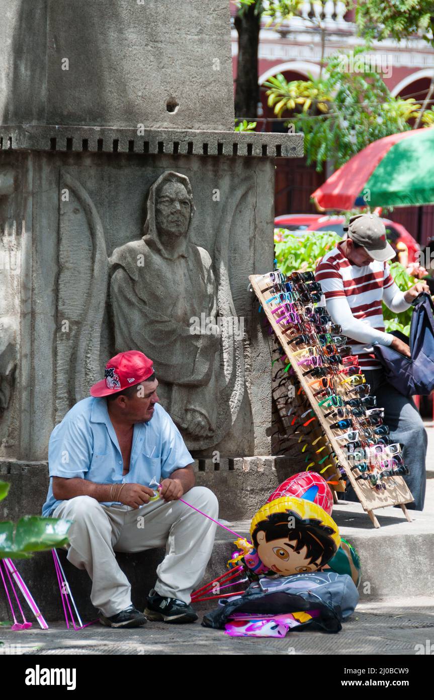 Man sitting and selling on the street in Central America Stock Photo