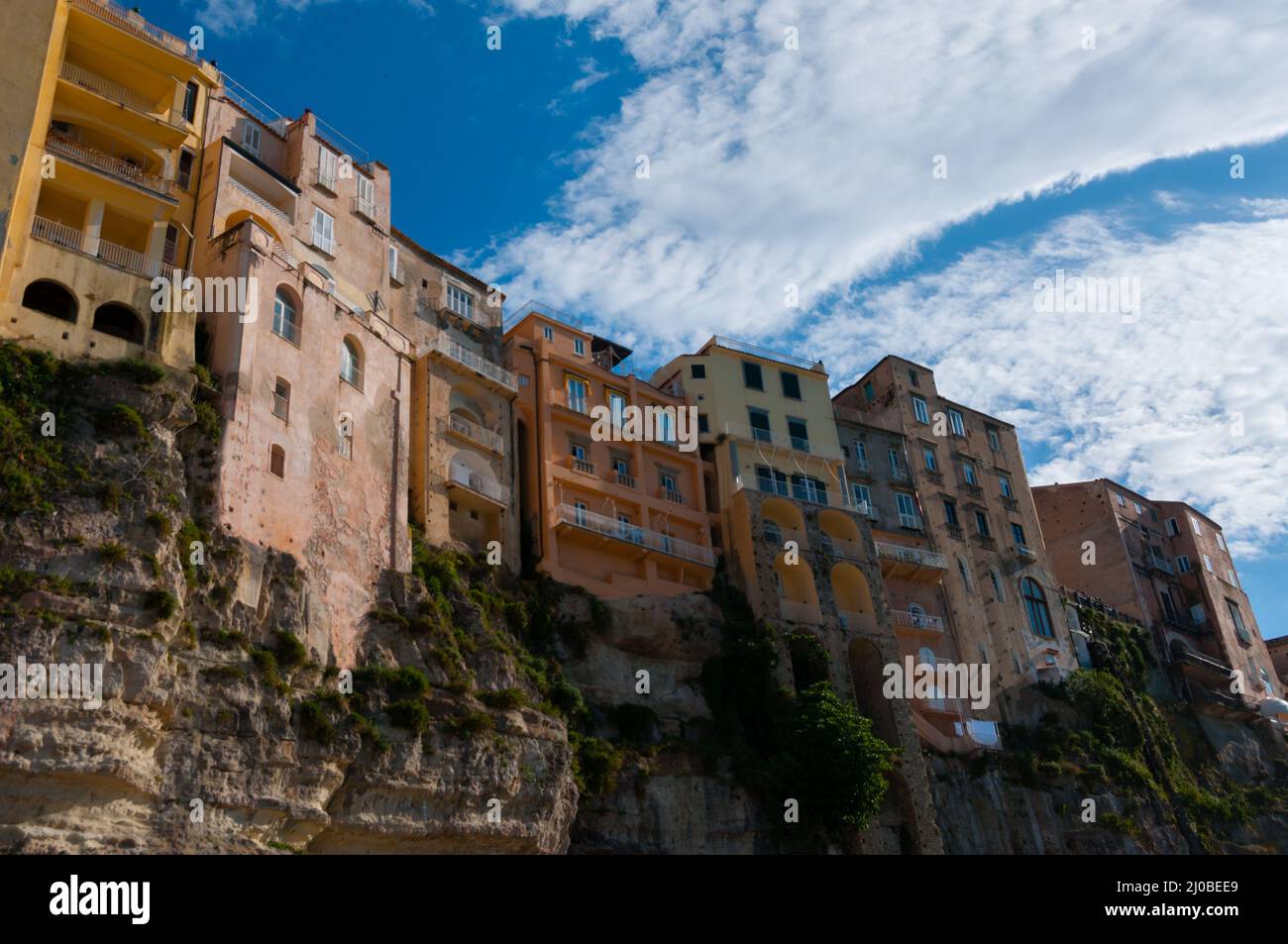Colorful houses under blue sky with cloud sitting on cliff of Tropea coast Stock Photo