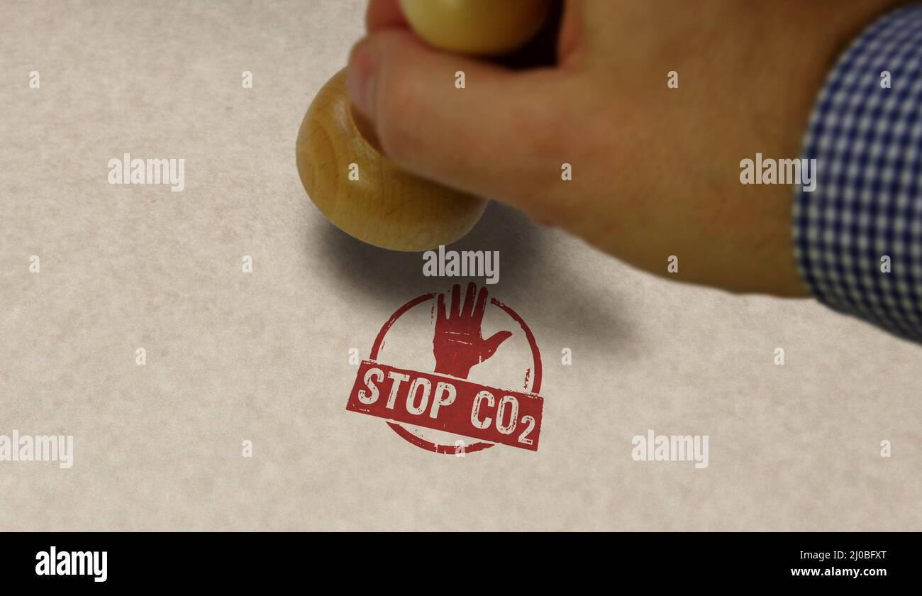 Stop CO2 and carbon neutral stamp and stamping hand. Eco, environment, zero emission and climate concept. Stock Photo