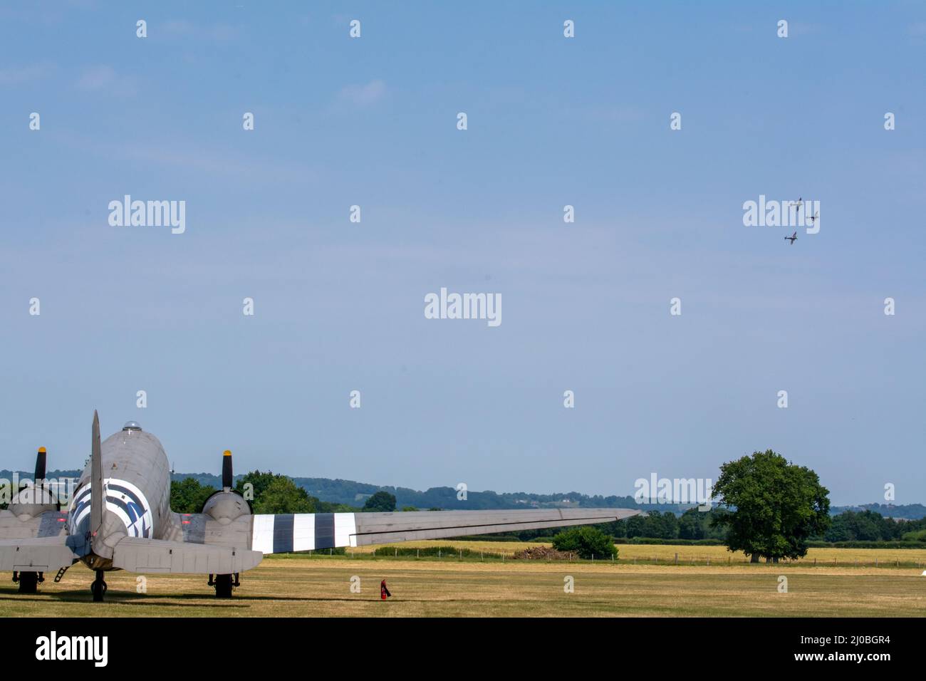 Headcorn, Kent  UK - July 1st 2018 A formation group of three spitfire WW2 fighter planes fly in airshow over Kent.  A USAF C-47 Skytrain is seen. Stock Photo