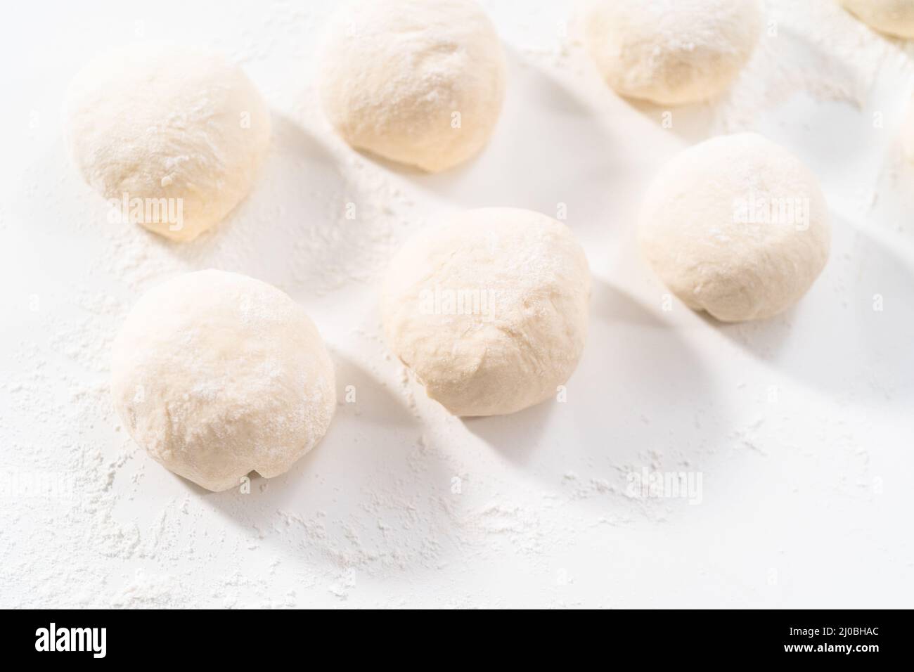 Rolling bread dough with a french rolling pin to make homemade