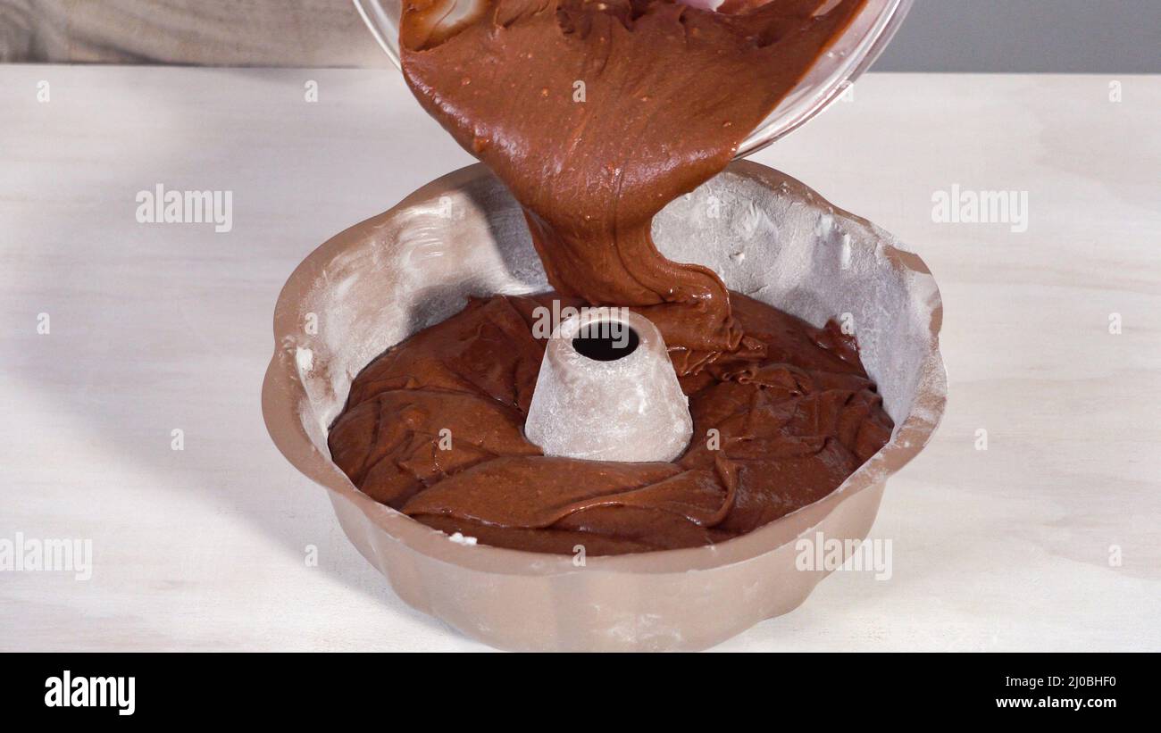 Step by step. Chocolate cake batter in a metal bundt cake pan ready for