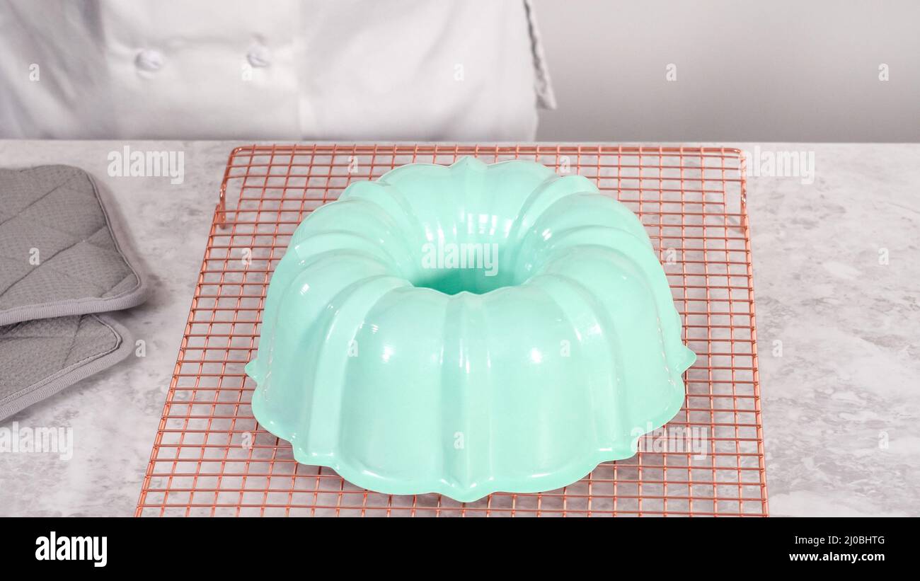 Step by step. Removing freshly baked funfettti bundt cake from the