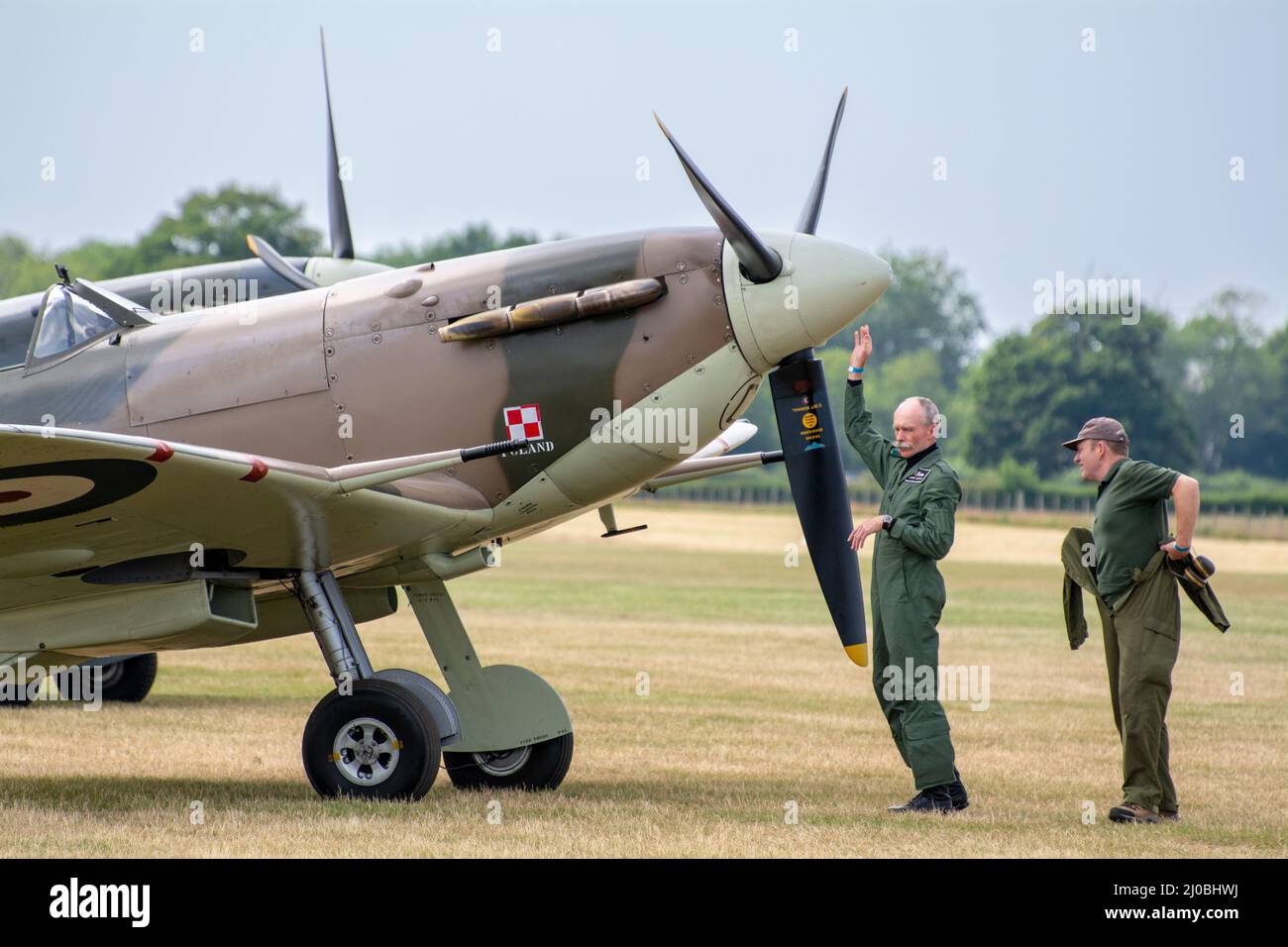Headcorn, Kent  UK - July 1st 2018 Royal Air Force ground crew do pre-flight checks and prepare a group of spitfire WW2 fighter planes for takeoff. Stock Photo
