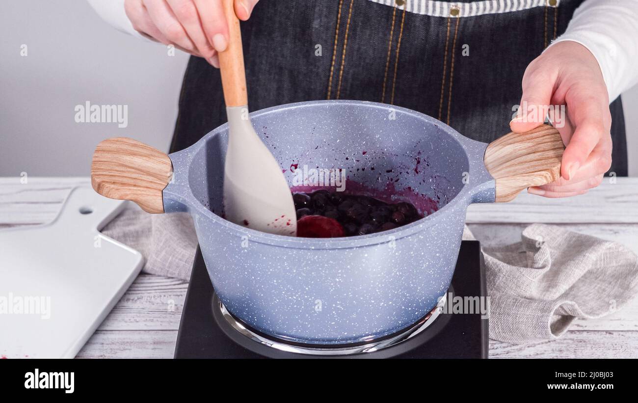 Step by step. Preparing mixed berry compote from frozen berries in a