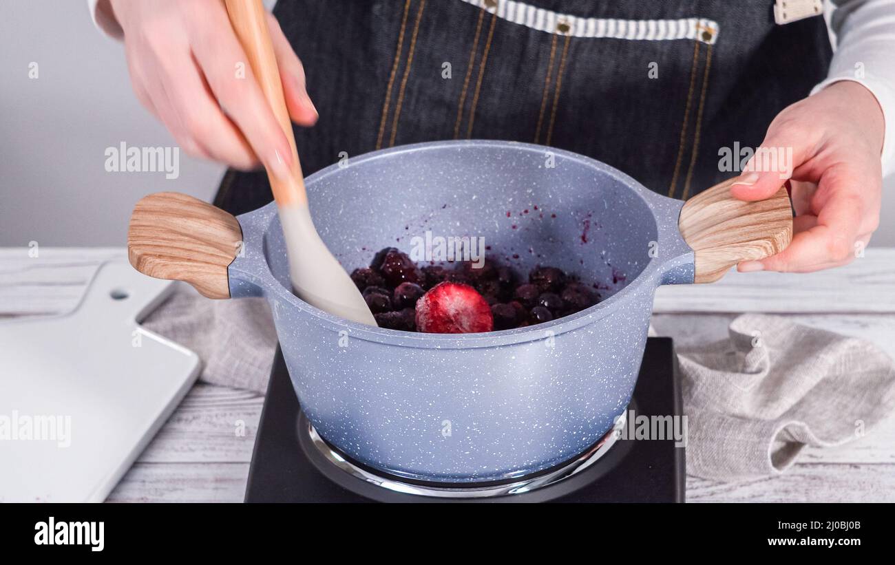 Step by step. Preparing mixed berry compote from frozen berries in a