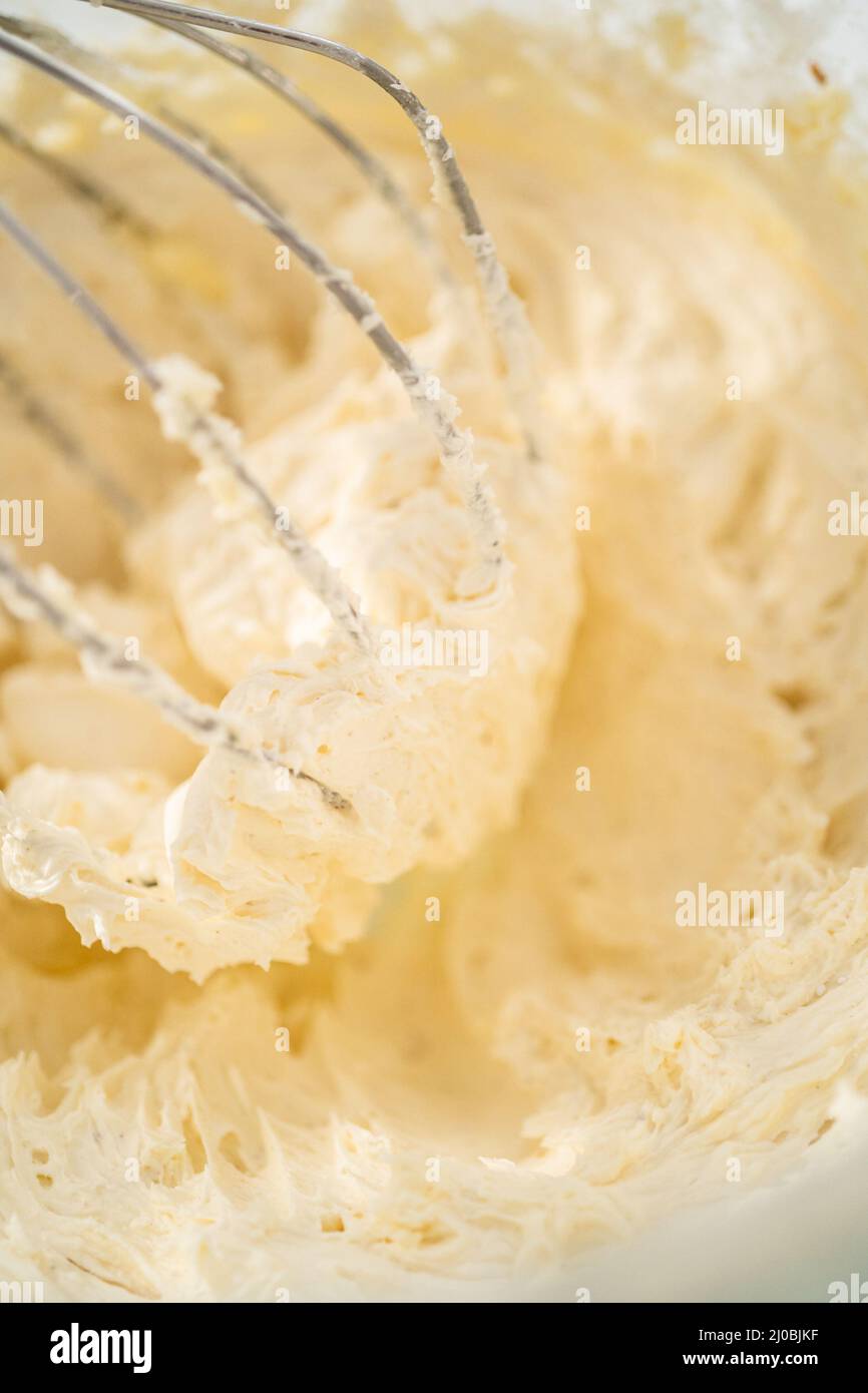 Mixing ingredients in a large glass mixing bowl of kitchen mixer to