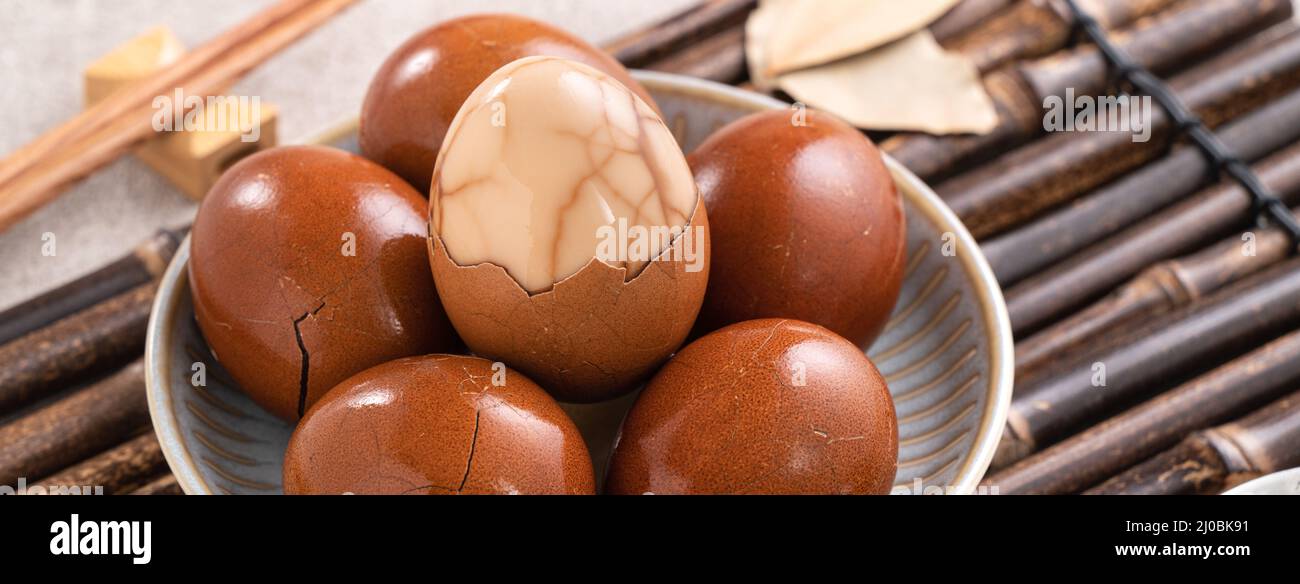 Close up of delicious traditional Taiwanese famous food tea eggs with in a bowl on gray table background. Stock Photo