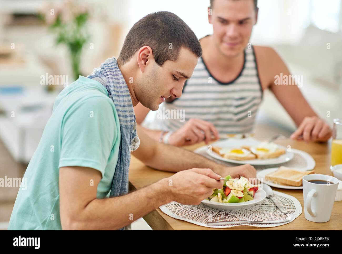 Enjoying a good meal and each others company. Shot of a gay couple having lunch together. Stock Photo