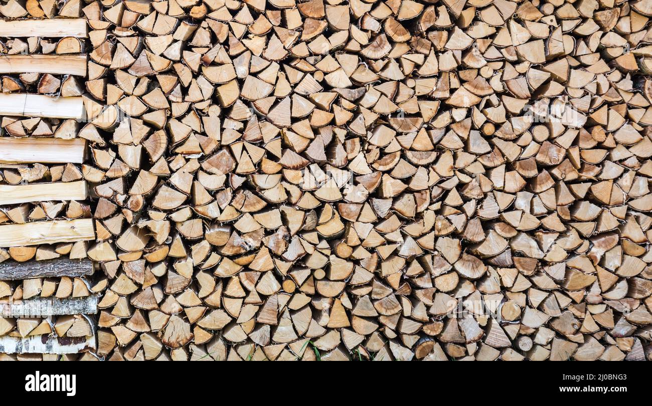 Close up of a patterned woodpile in front of a typical Swedish house, Segersta, Sweden Stock Photo