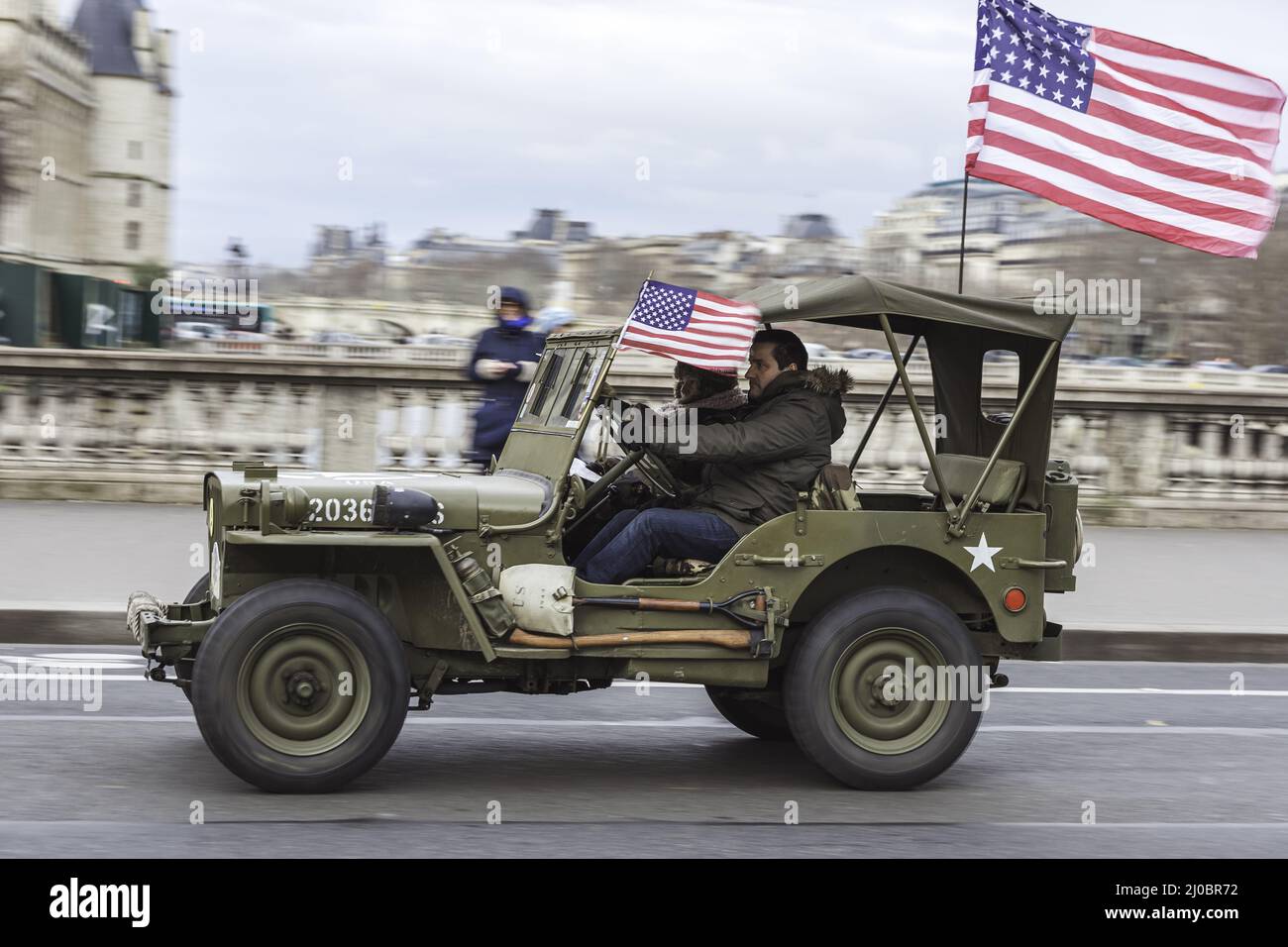 Old American off road vehicle used in World War II driving in the city