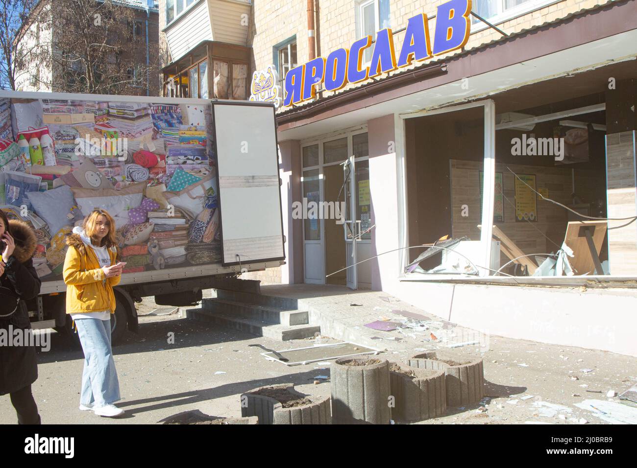Local residents shocked by carnage of a small convenience store Yaroslav destroyed by missile blast on 18 March in west part of Kiev on Mezhova street Stock Photo