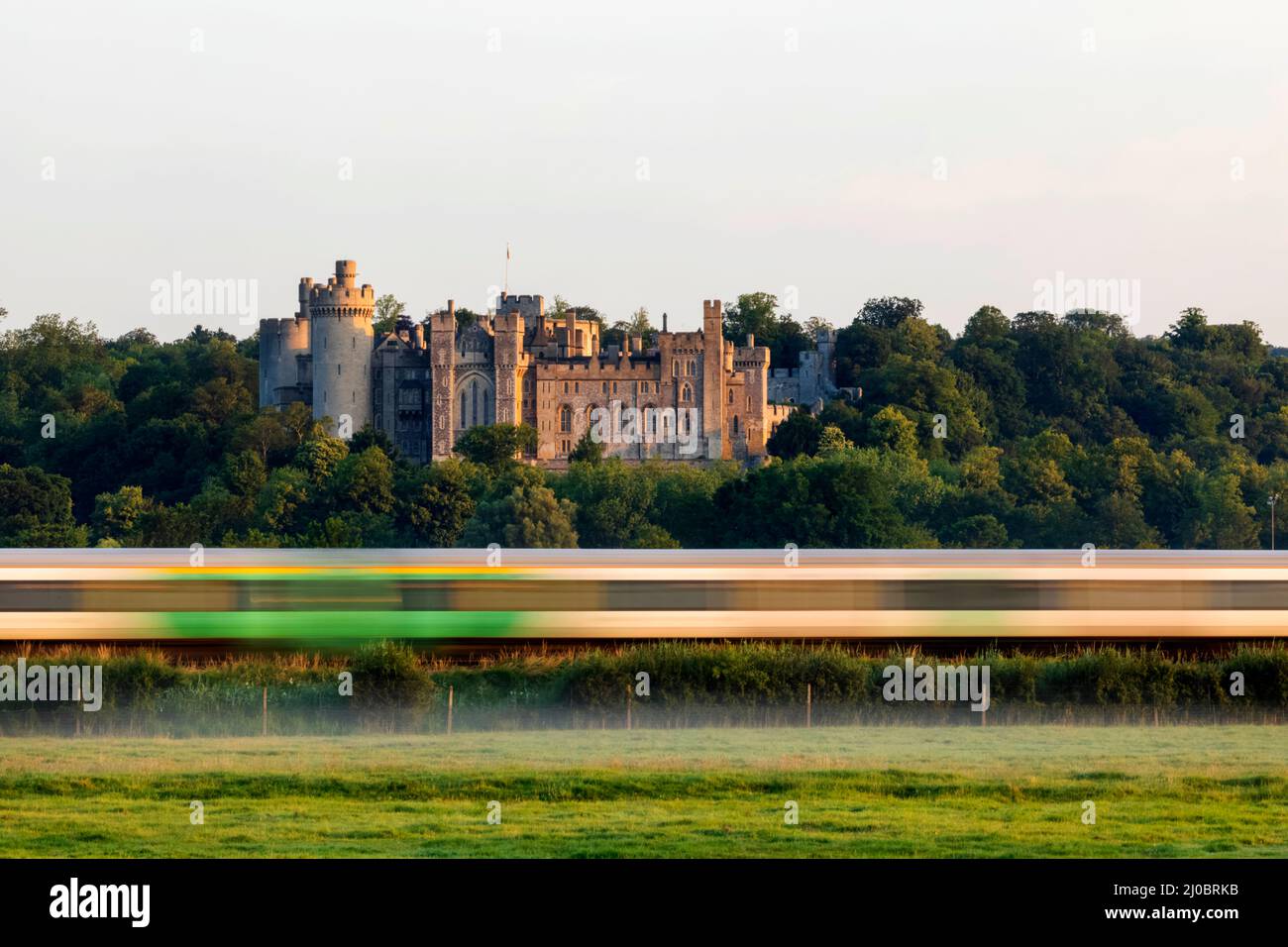 England, West Sussex, Arundel, Train Passing by Medieval Arundel Castle and Early Morning Mist Stock Photo