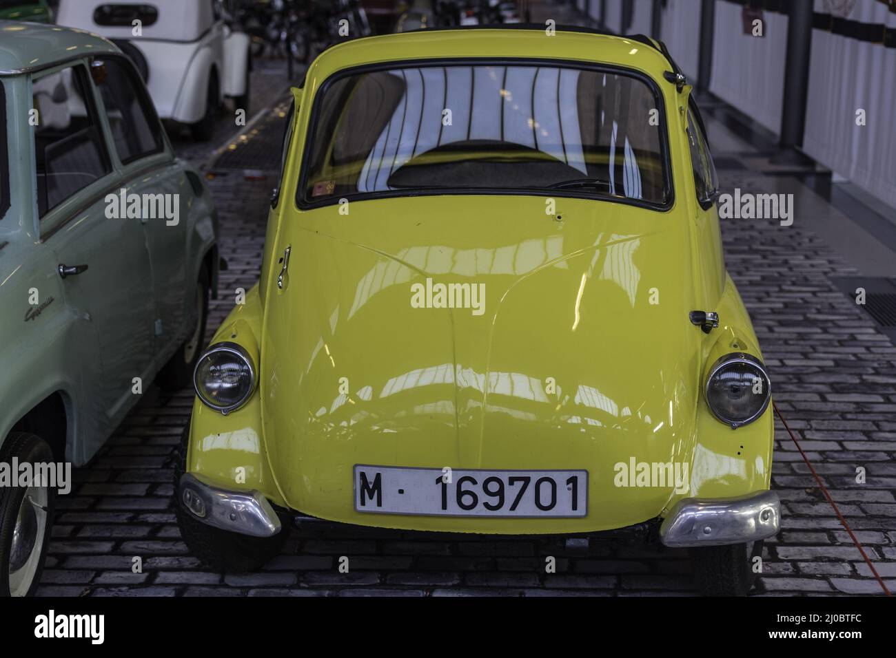 Iconic European car, yellow Isetta with one front door. Barcelona, Spain Stock Photo