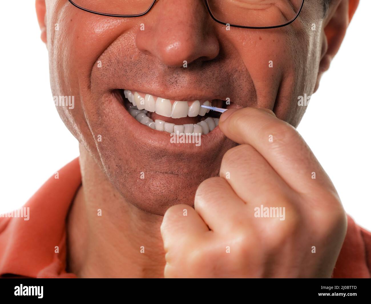 teeth cleaning a dental stick, a man cleans white teeth Stock Photo