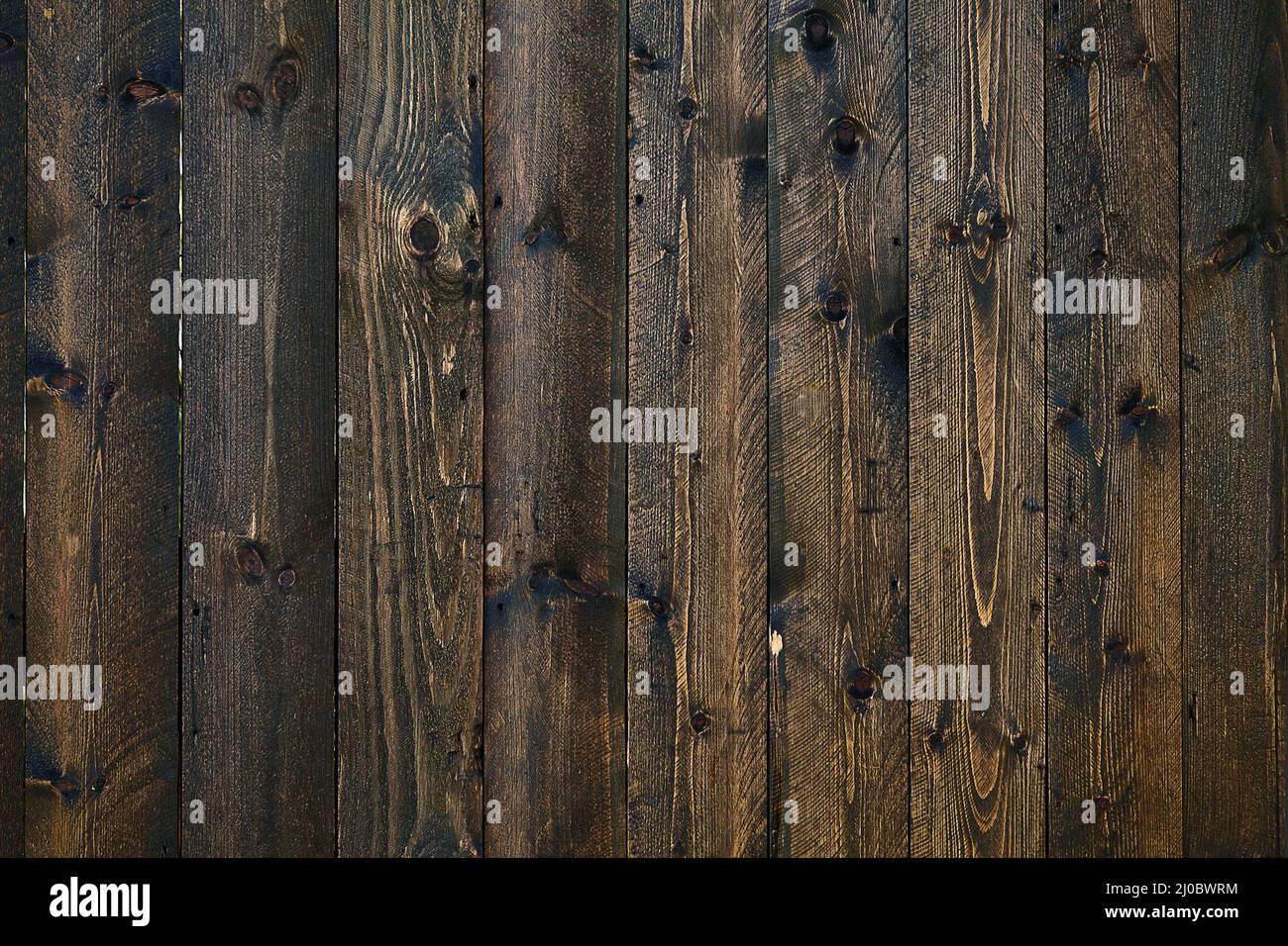 Background texture of dark brown planks closeup Stock Photo