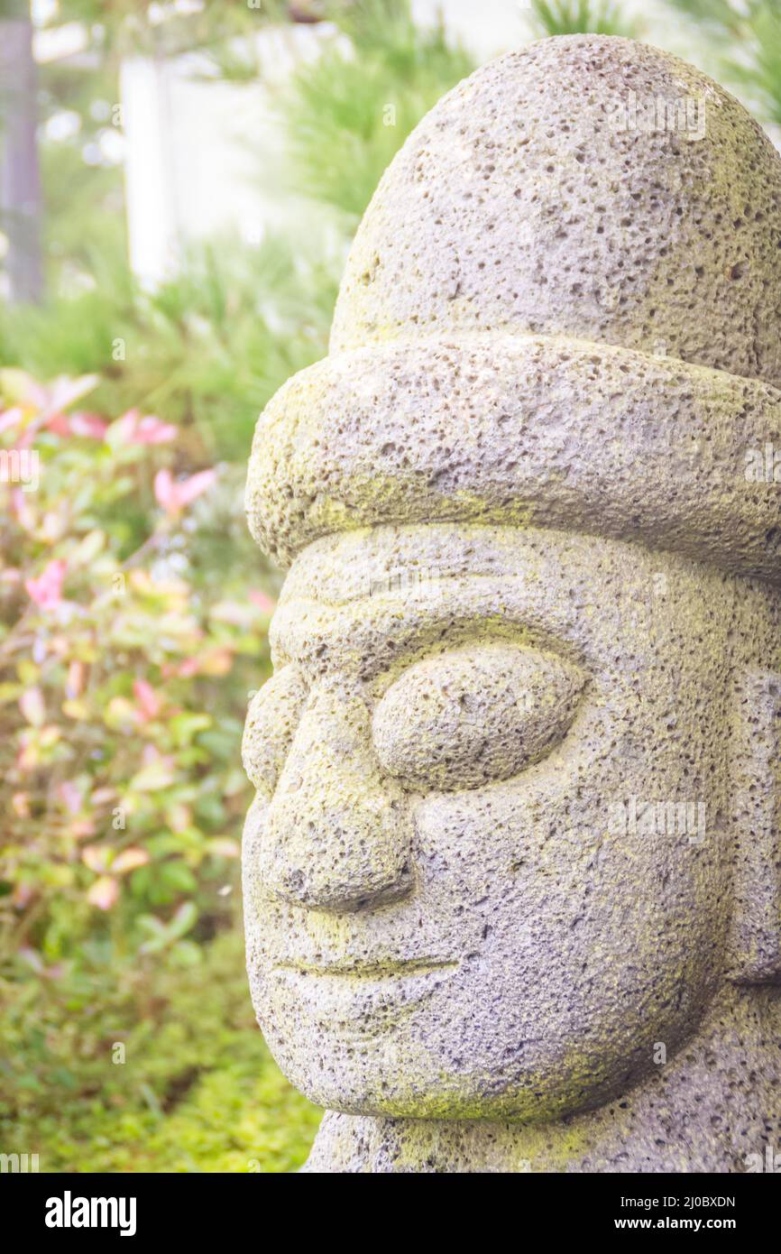 Close up face of the stone idol (Dolharubang, the grandfather stones) near by Jeju walking street, Jeju Island, South Korea Stock Photo
