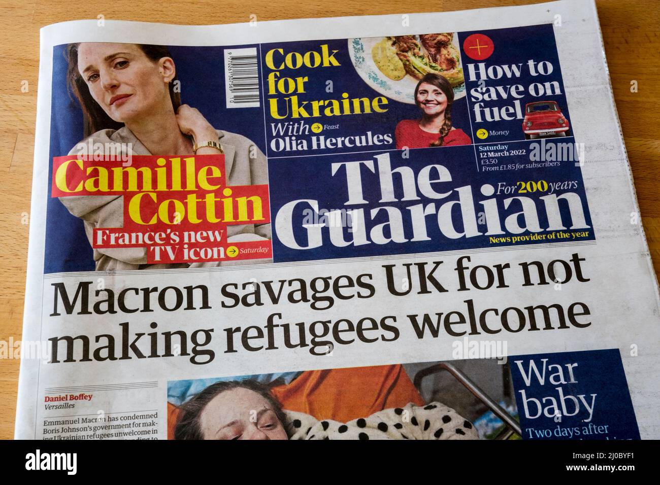 12 March 2022 Guardian newspaper headline about the Ukraine crisis reads 'Macron savages UK for not making refugees welcome. Stock Photo