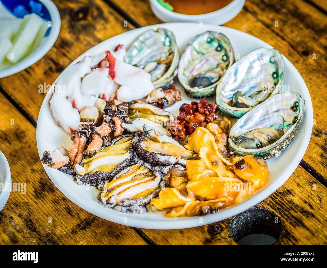 Set of raw seafood served to customer that ready to eat in raw seafood shop near Seongaksan mountain, Jeju island, South Korea. Stock Photo