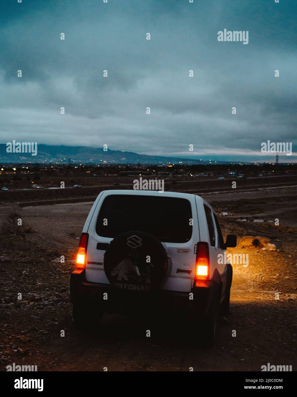 Vertical shot of a suzuki jeep desert in the evening Stock Photo