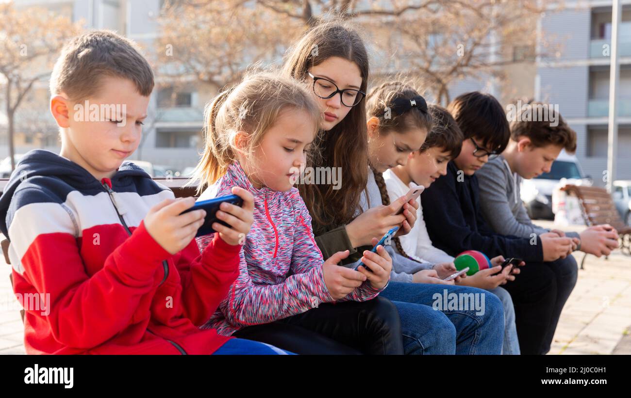 Group of children communicate using smartphones in the playground Stock ...