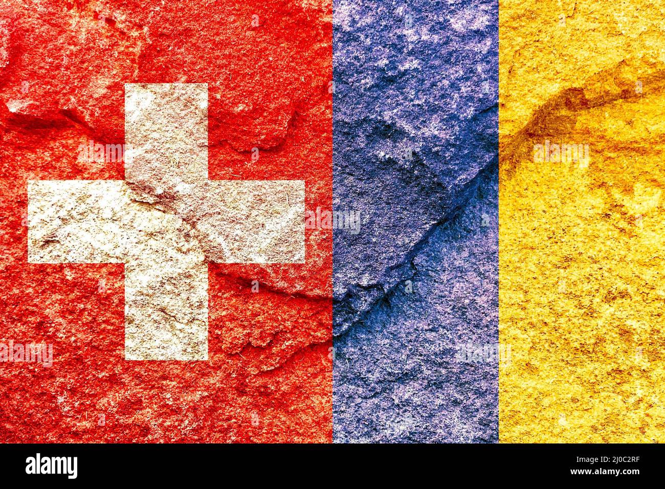 Swiss and Ukraine vertical flags isolated together on weathered stone wall Stock Photo