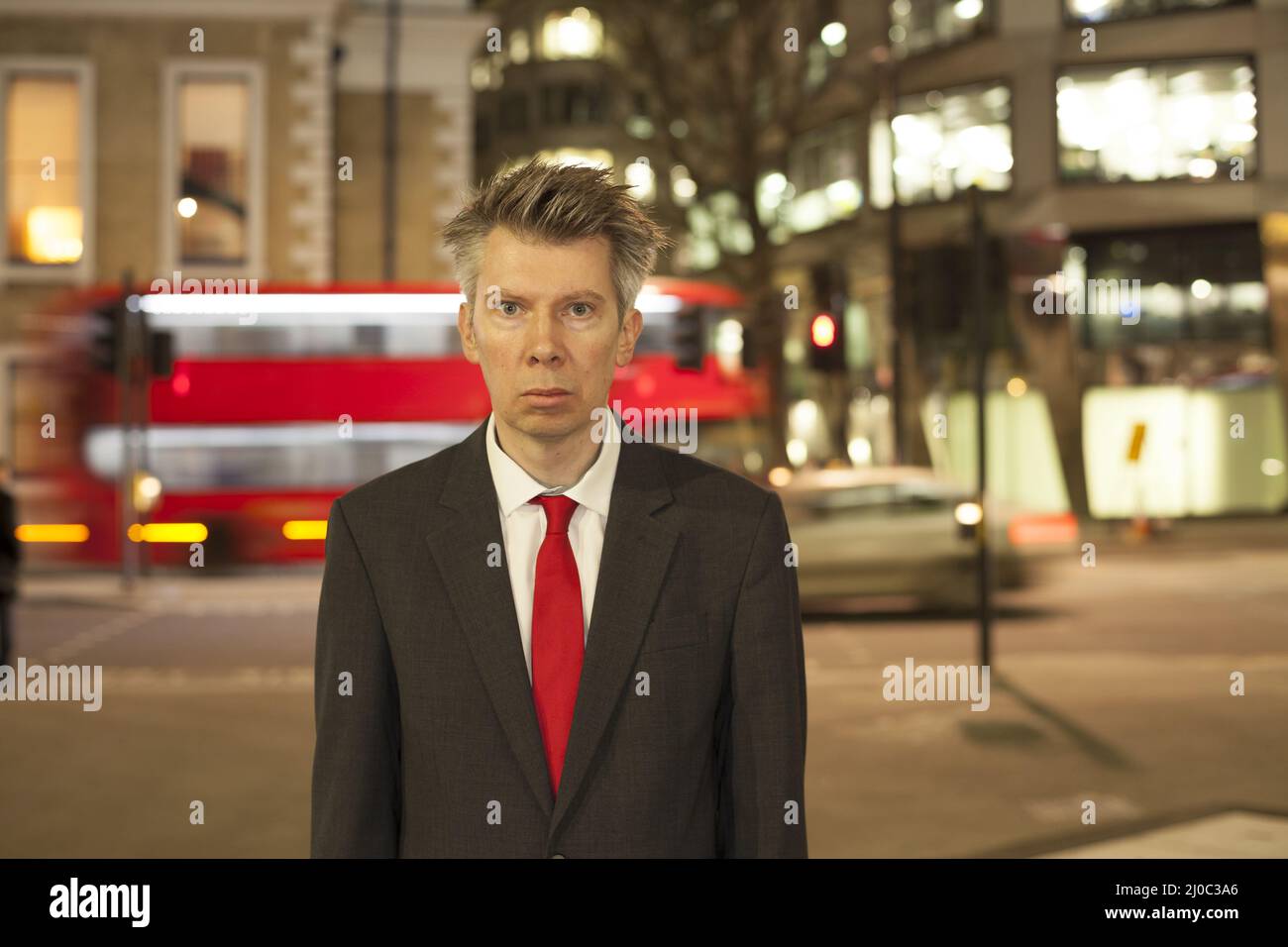 Businessman standing still at night Stock Photo