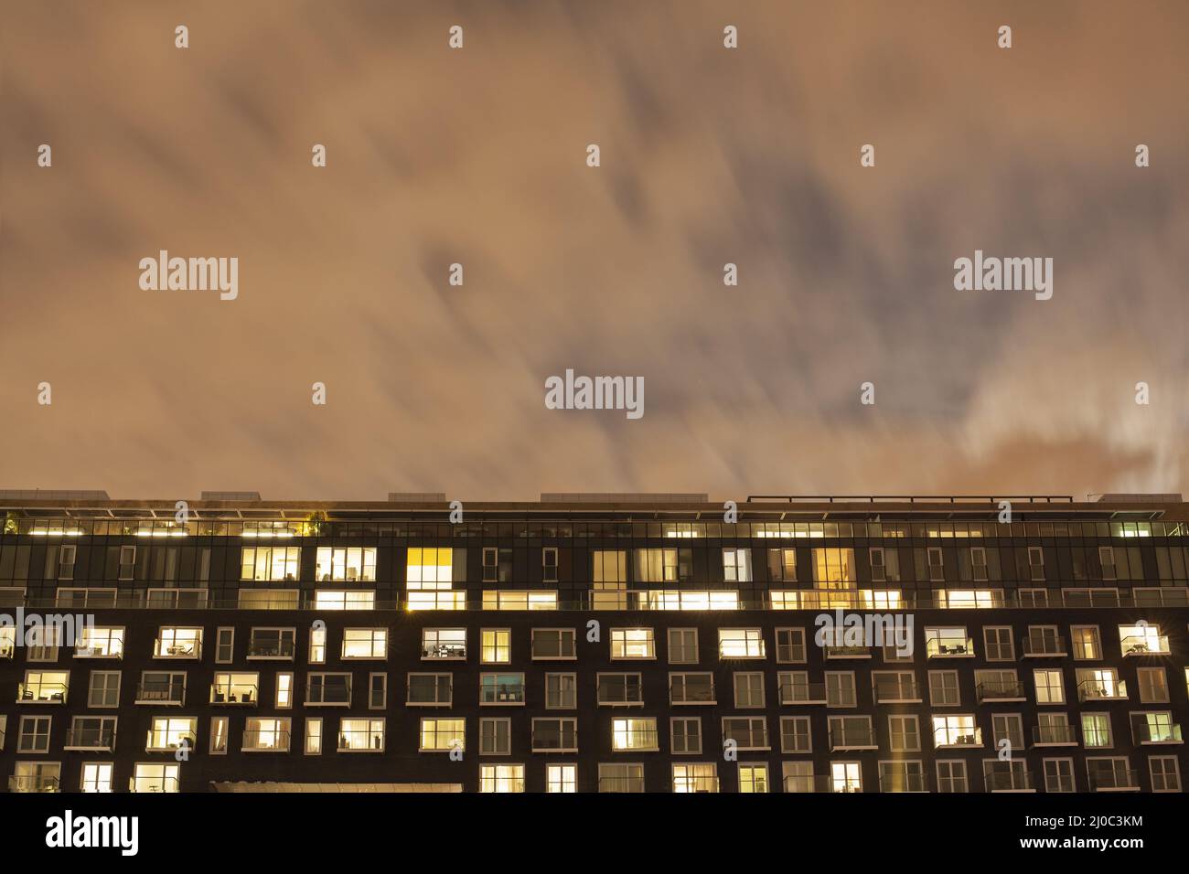 Modern apartment block at night Stock Photo