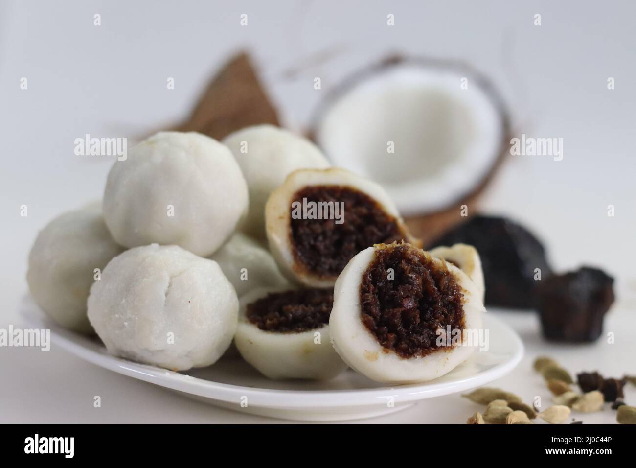 Steamed rice dumpling with a filling of palm jaggery and freshly grated coconut. Popular food of kerala commonly called Kozhikatta. Shot with blocks o Stock Photo