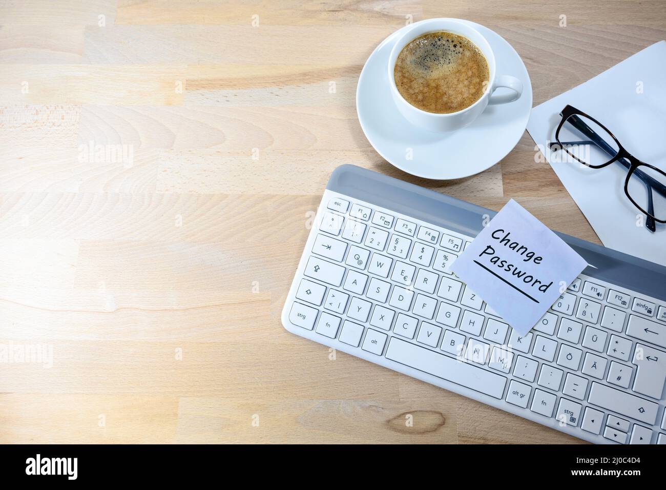 Change Password, written on a sticky note on a computer keyboard