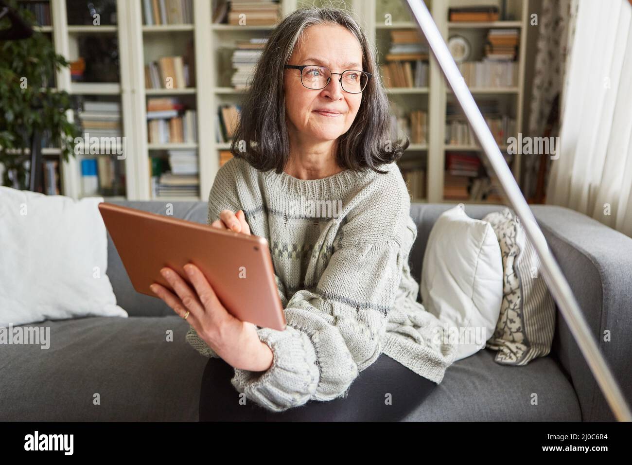 Old woman sitting alone sofa hi-res stock photography and images - Alamy