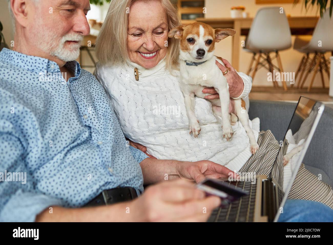 Senior couple at laptop computer shopping online for e-commerce and paying by credit card Stock Photo